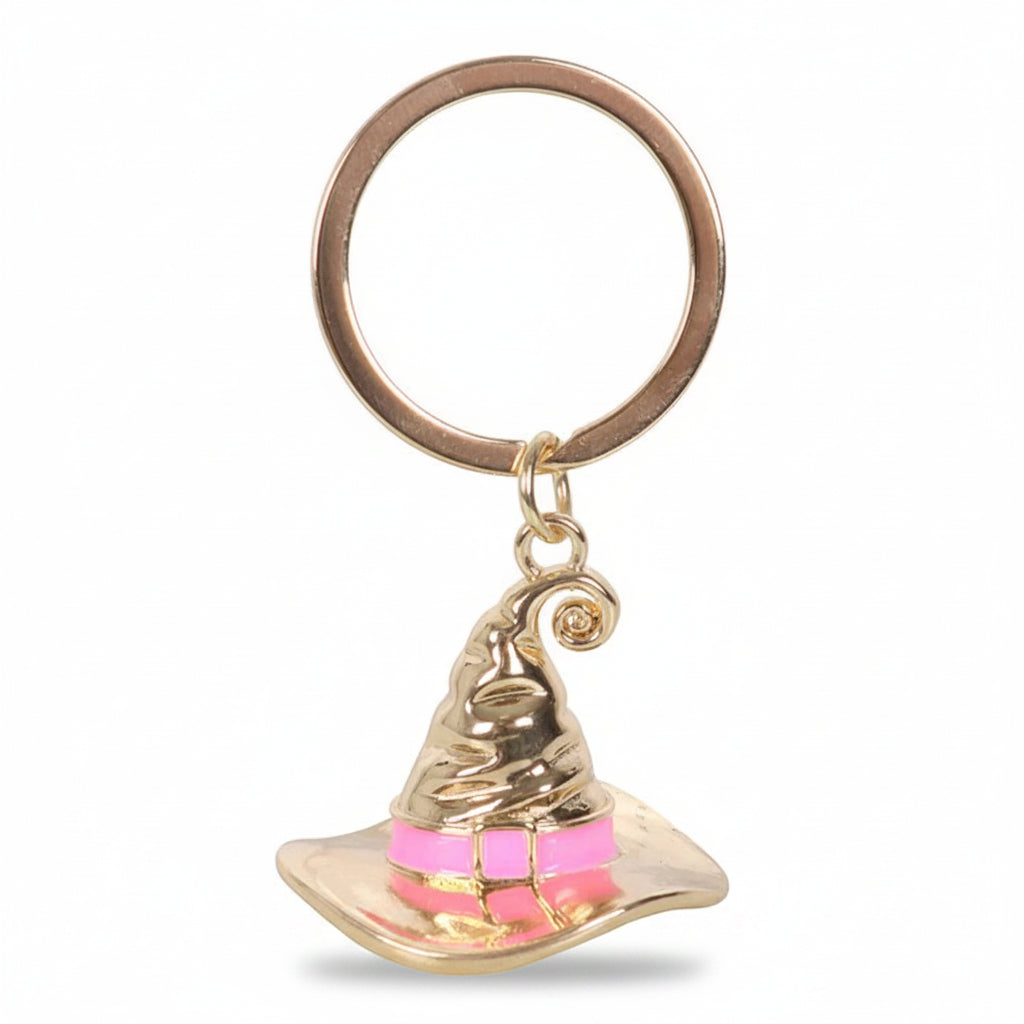 Gold-tone metal witch hat keyring with pink band, engraved Good Witch text.