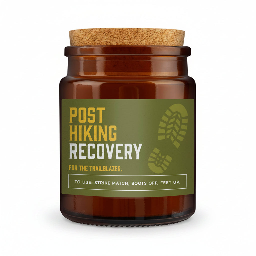 An amber glass jar with a cork lid and a green label reading 'POST HIKING RECOVERY' in yellow and white text, set against a textured gray background.