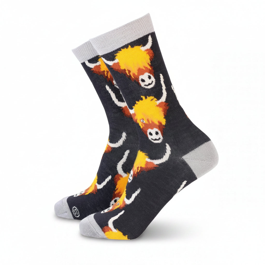 Women’s bamboo socks with Highland cow design in black and grey with yellow and orange detail.