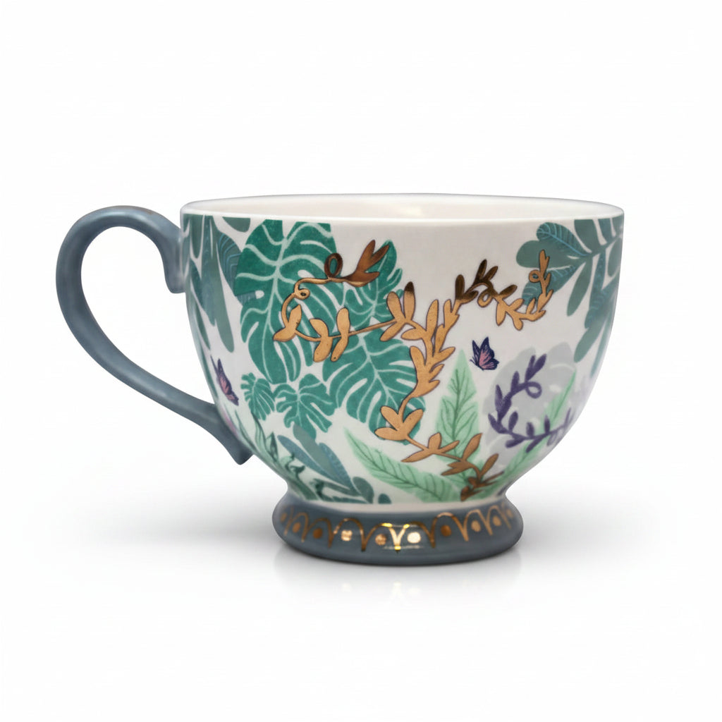 Porcelain foliage mug with blue handle and intricate botanical design.
