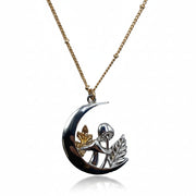 Studio shot of the Forage Moon Necklace with clear white background, showcasing silver crescent pendant and gold-tone chain in full detail.