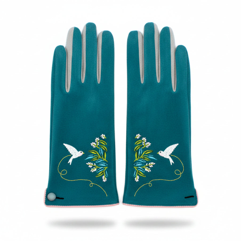 Top-down view of both teal gloves laid flat, featuring mirrored bird and foliage embroidery on the wrists.