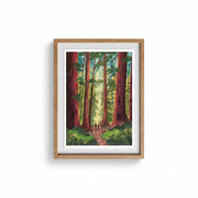 Into the Trees Version 2 art print A4 by Charis Raine Illustration framed on wall, featuring giant redwood trees and woodland path.