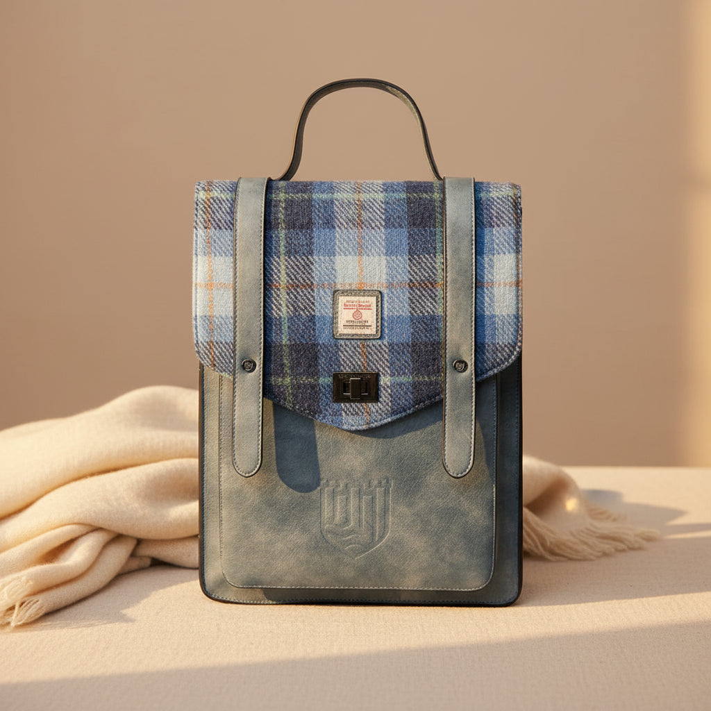 Blue plaid bag with leather accents on a white background