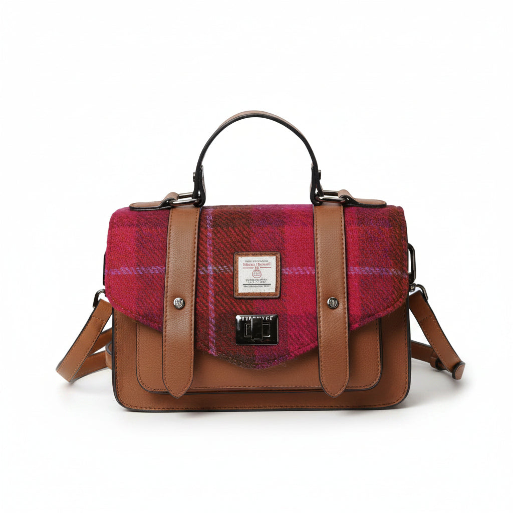 Front view of Fuchsia Red Tartan Harris Tweed® satchel with detachable strap and silver clasp detail.