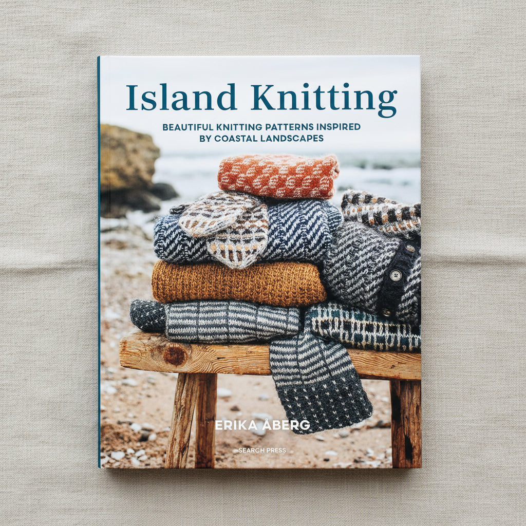 Island Knitting hardback book cover with colourful knitted items on coastal bench