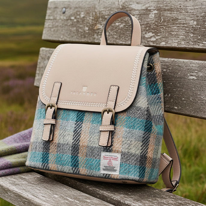 Harris Tweed Islander tartan mini backpack on bench in Scottish moorland