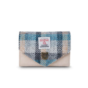 Front view of a small Harris Tweed purse with a blue and grey tartan flap, soft cream body, and Islander metal crest detail.
