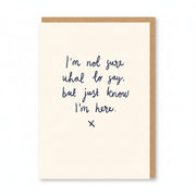 Cream sympathy card with handwritten navy script and a small kiss