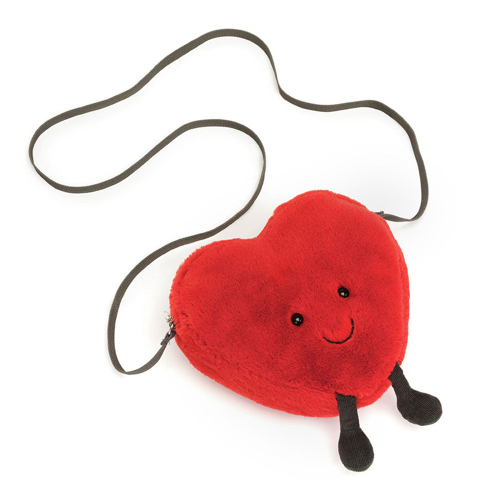 Jellycat Heart Bag lying flat with strap extended, showing zip closure and plush fabric.