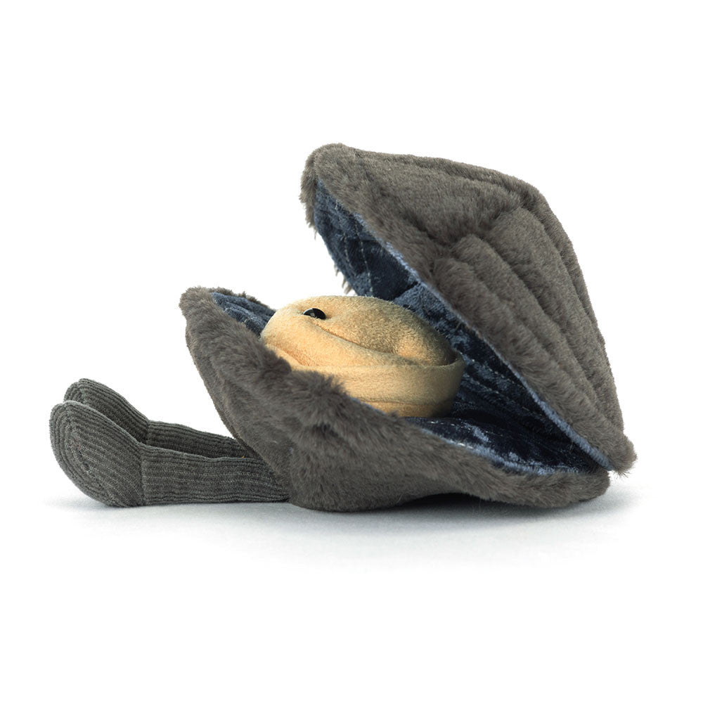 Side view of Jellycat Michelle Mussel with smiling face peeking from shell.