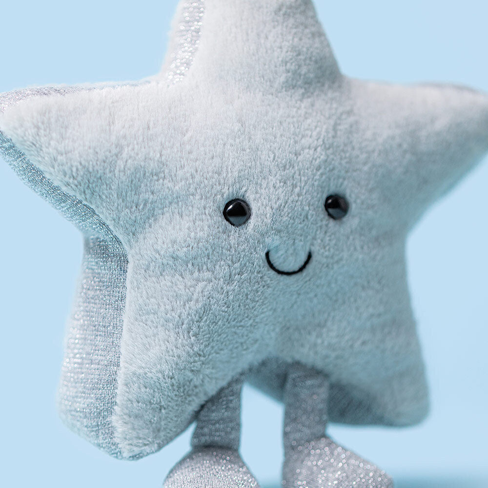 Close-up of Jellycat Amuseables Silver Star showing soft grey plush and sparkly metallic texture.