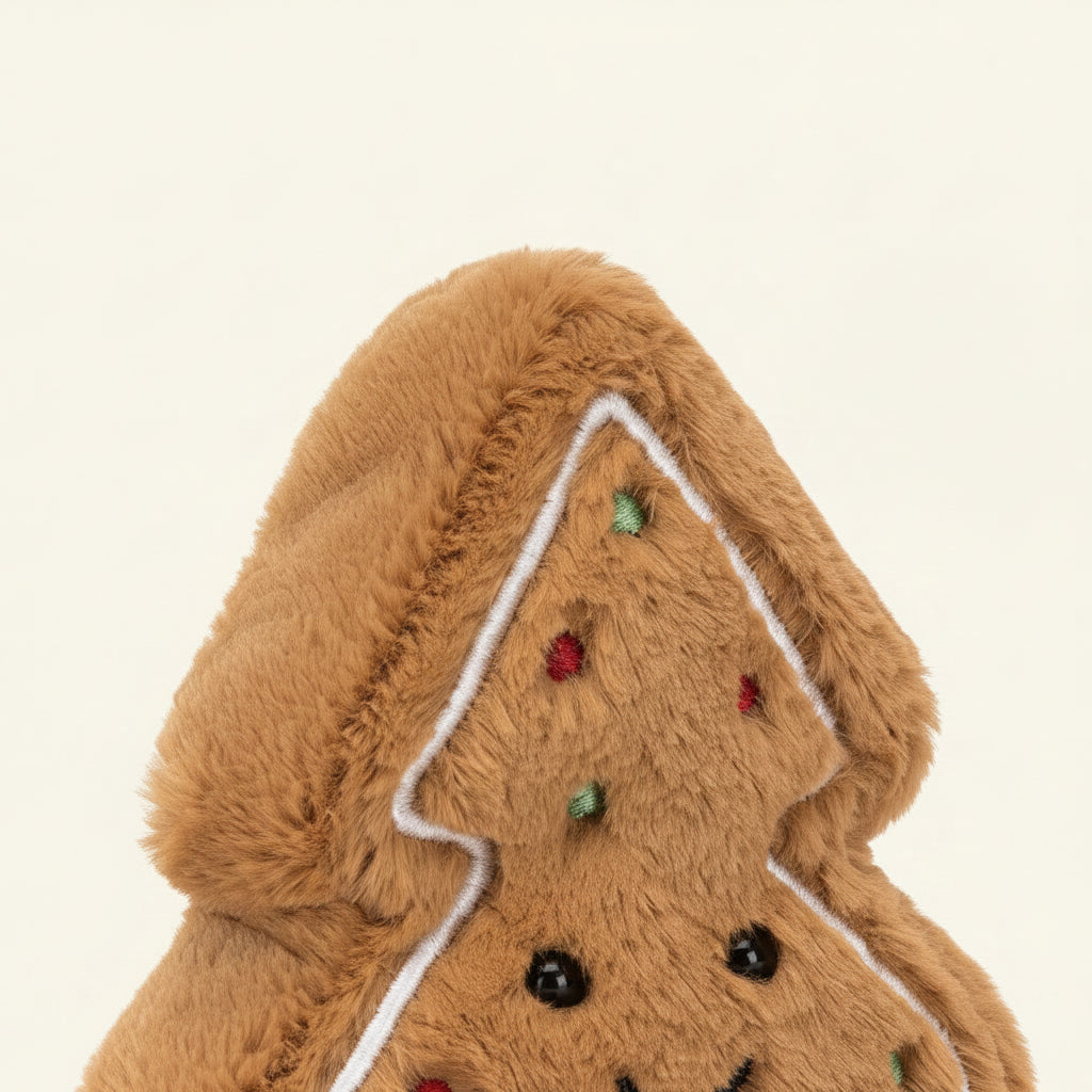 Plush gingerbread cookie toy with a smiley face on a white background