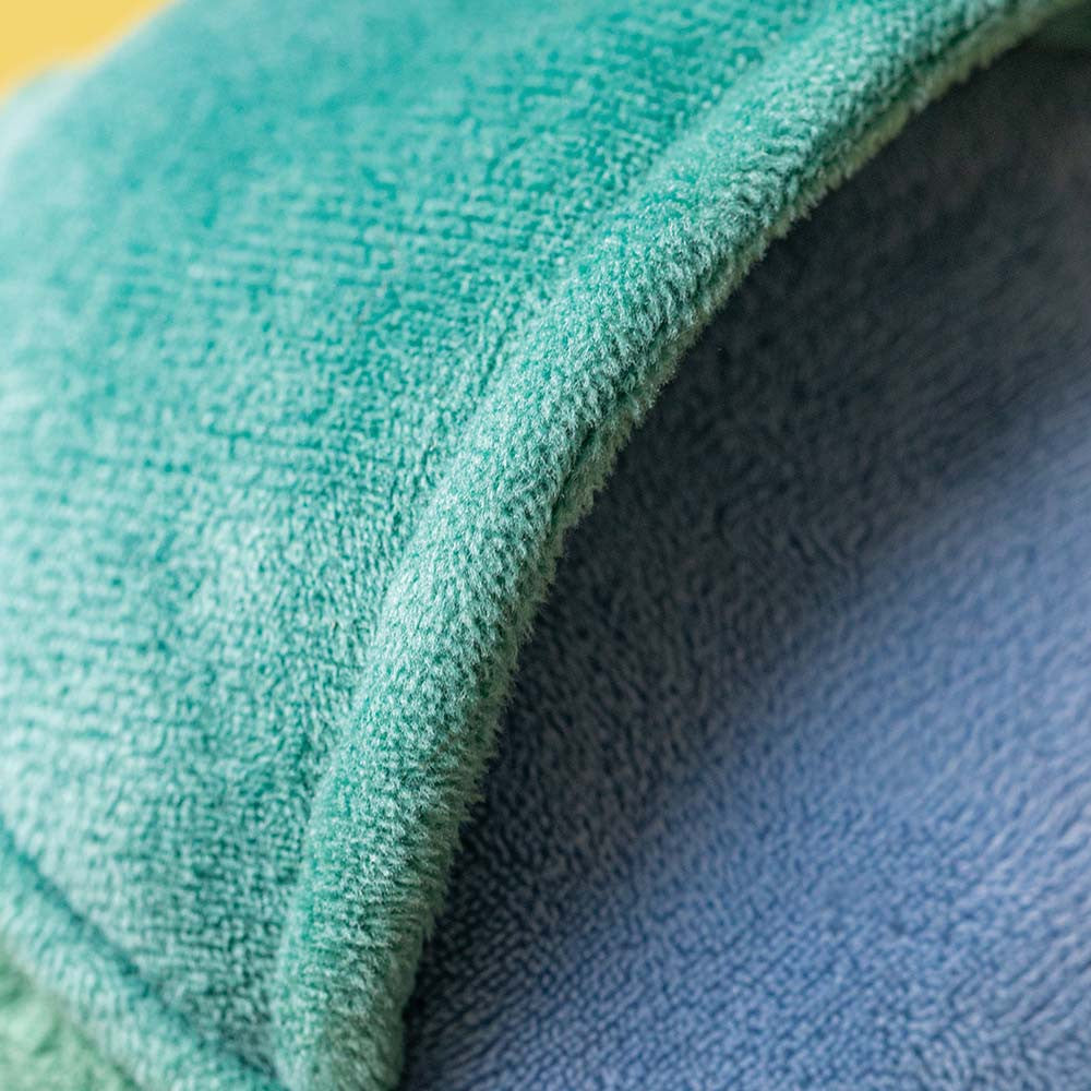 Close-up of Jellycat watering can green and blue plush fabric texture