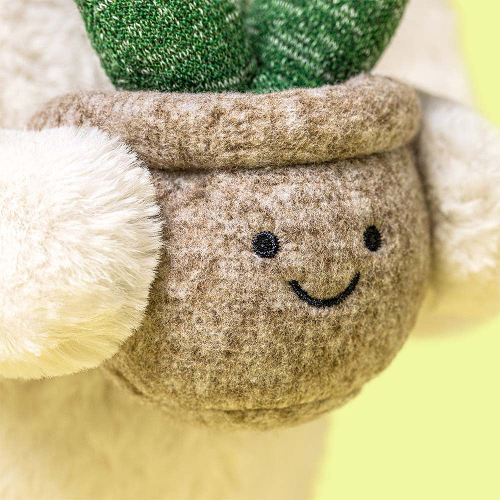 Close-up of smiley potted plant accessory on yellow background