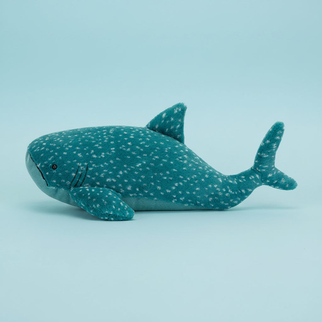 Side profile of Jellycat Gobfrey Whale Shark plush toy – Showcasing the shark’s flappy fins, curved tail, and dotted pattern across its body.
