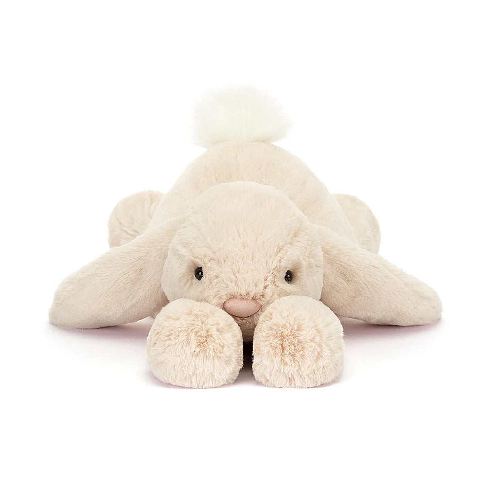   close up of Jellycat Smudge Rabbit with oatmeal coloured fur, long floppy ears and a white fluffy tail.