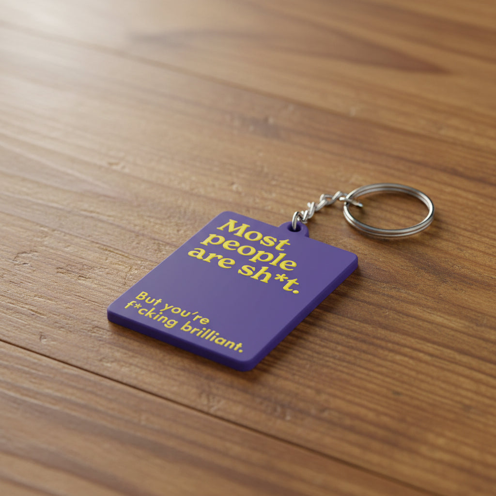 Purple keychain with yellow text on a white background