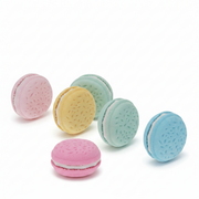 Five pastel macaron erasers scattered showing pull-apart halves