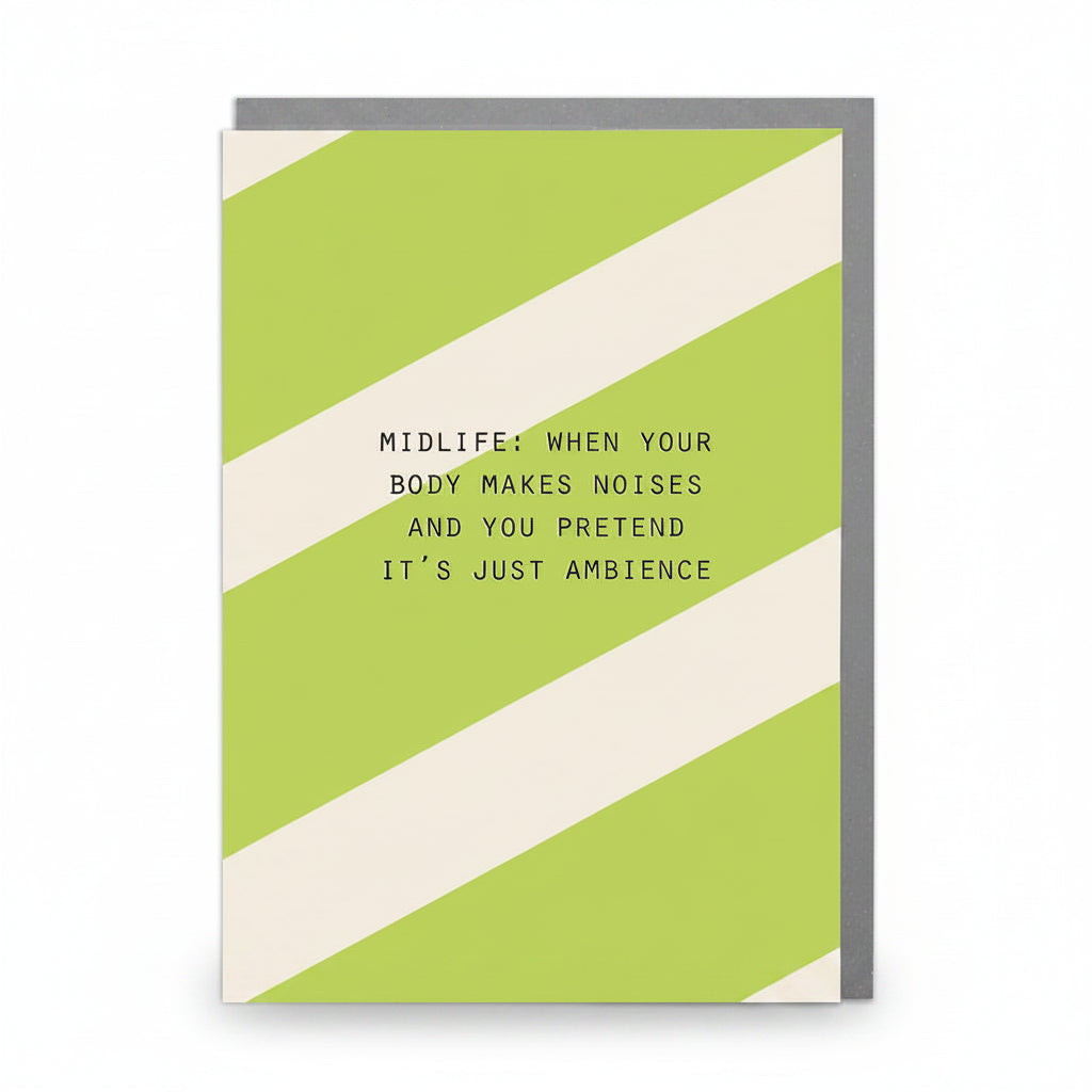 Front of Midlife Noises Humorous Card featuring green and cream diagonal stripes with the quote “Midlife: when your body makes noises and you pretend it’s just ambience.”