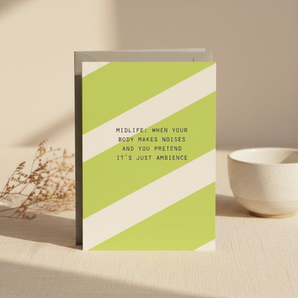 Card with green and white diagonal stripes and humorous text on a white background