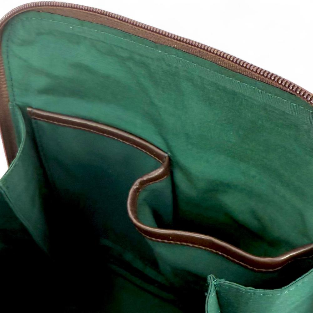 Country Green Harris Tweed mini backpack interior showing zip pocket and lining.