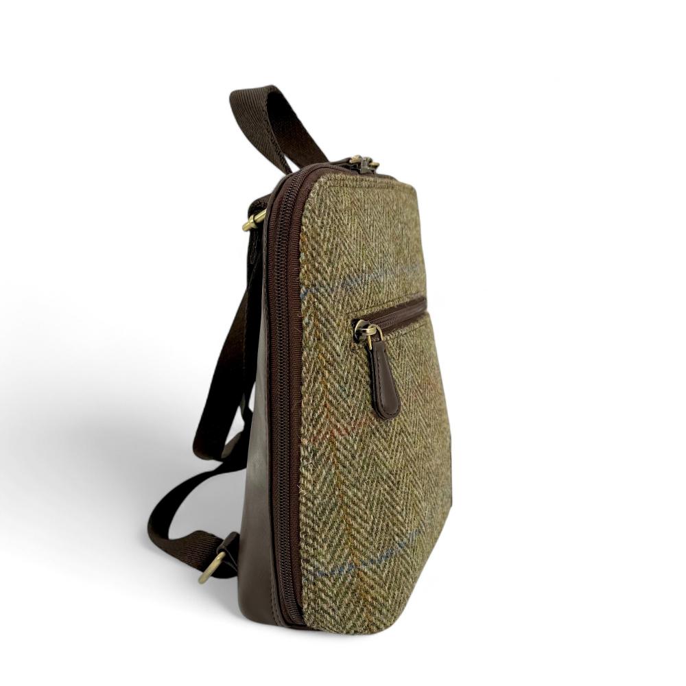 Country Green Harris Tweed mini backpack side view showing zip pocket on white background.