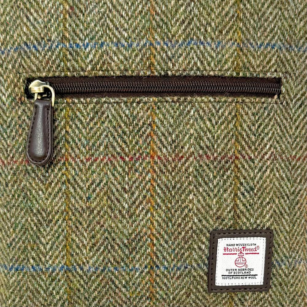 Close-up of country green Harris Tweed herringbone texture and label.