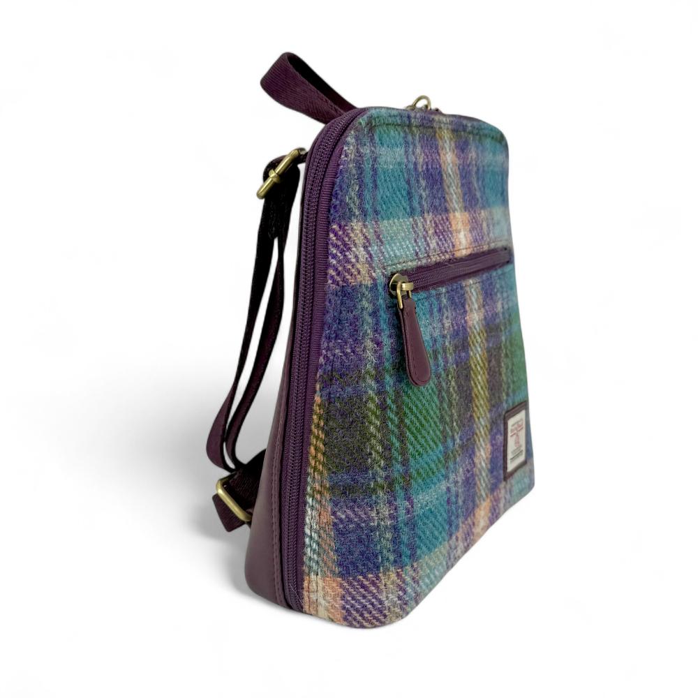 Green And Purple Plaid Harris Tweed mini backpack side view showing zip pocket on white background.