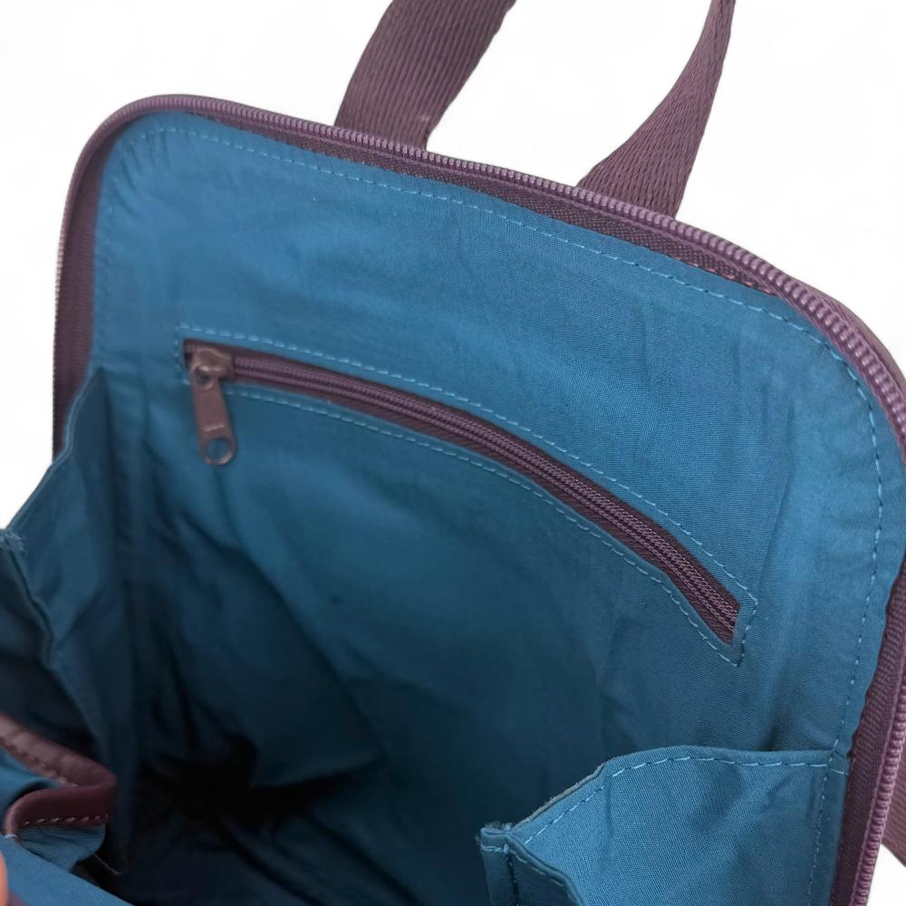 Pastel Pink Harris Tweed mini backpack interior showing zip pocket and lining.
