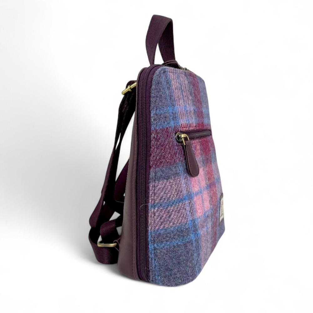 Pastel Pink Harris Tweed mini backpack side view showing zip pocket on white background.