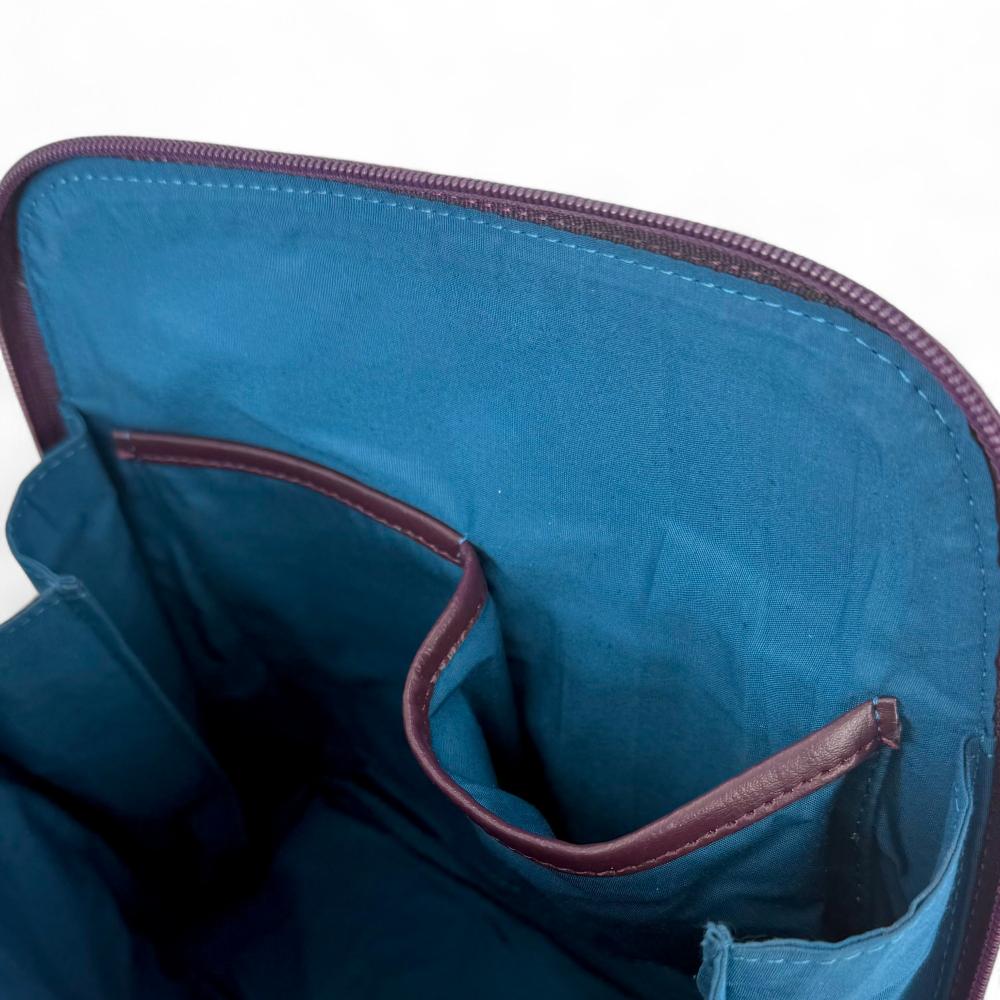 Maccessori embossed branding on purple vegan leather back panel.