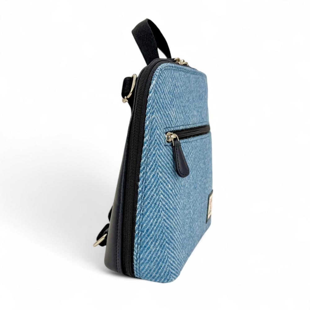 Sky Blue Harris Tweed mini backpack side view showing zip pocket on white background.