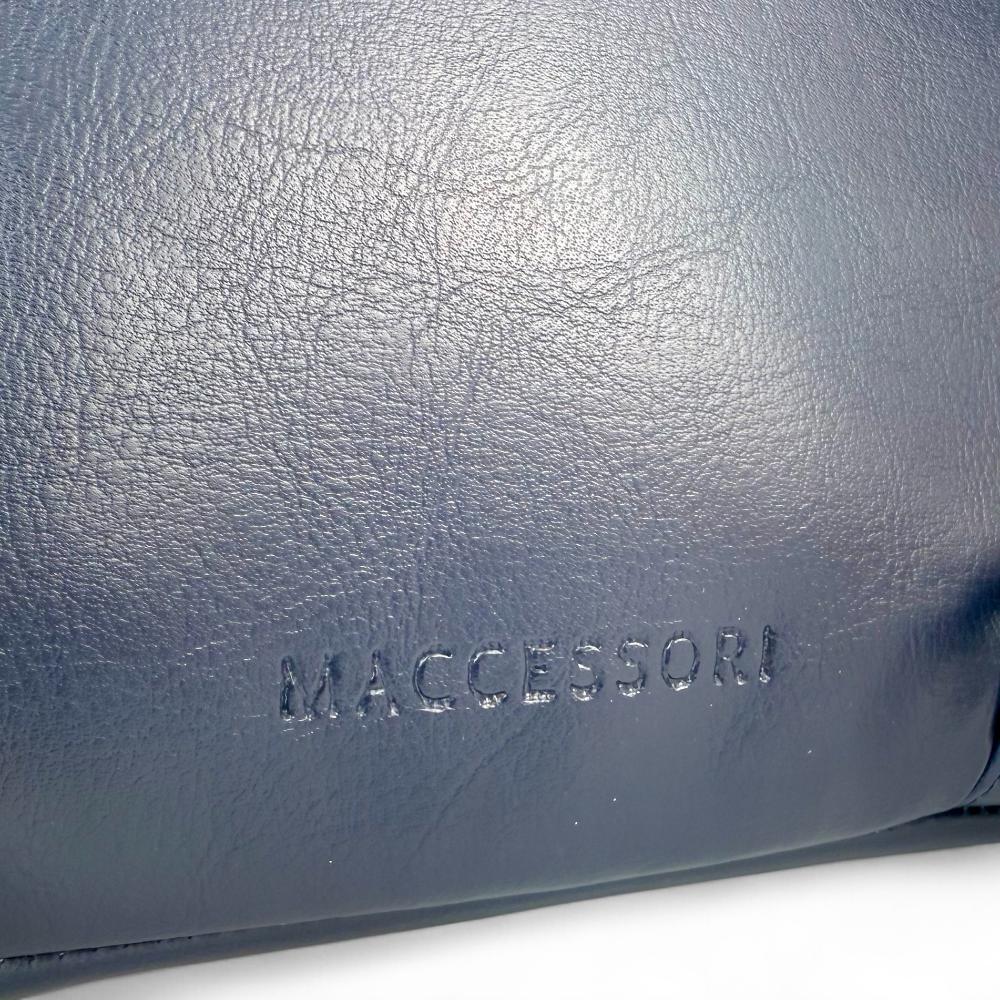 Maccessori embossed branding on navy vegan leather back panel.