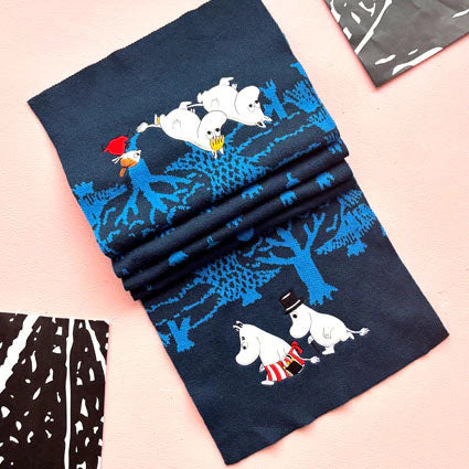 Folded Moomin Blue Forest Embroidered Scarf showing Moomin family and Little My embroidered on a moonlit forest pattern.