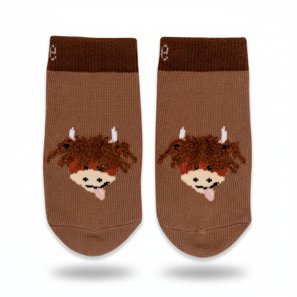 Flat lay of Neutral Highland Cow Socks showing knit texture and fun design