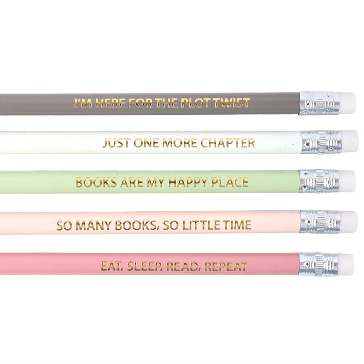 Close-up of gold-foil book quote pencils reading “I’m here for the plot twist” and more.
