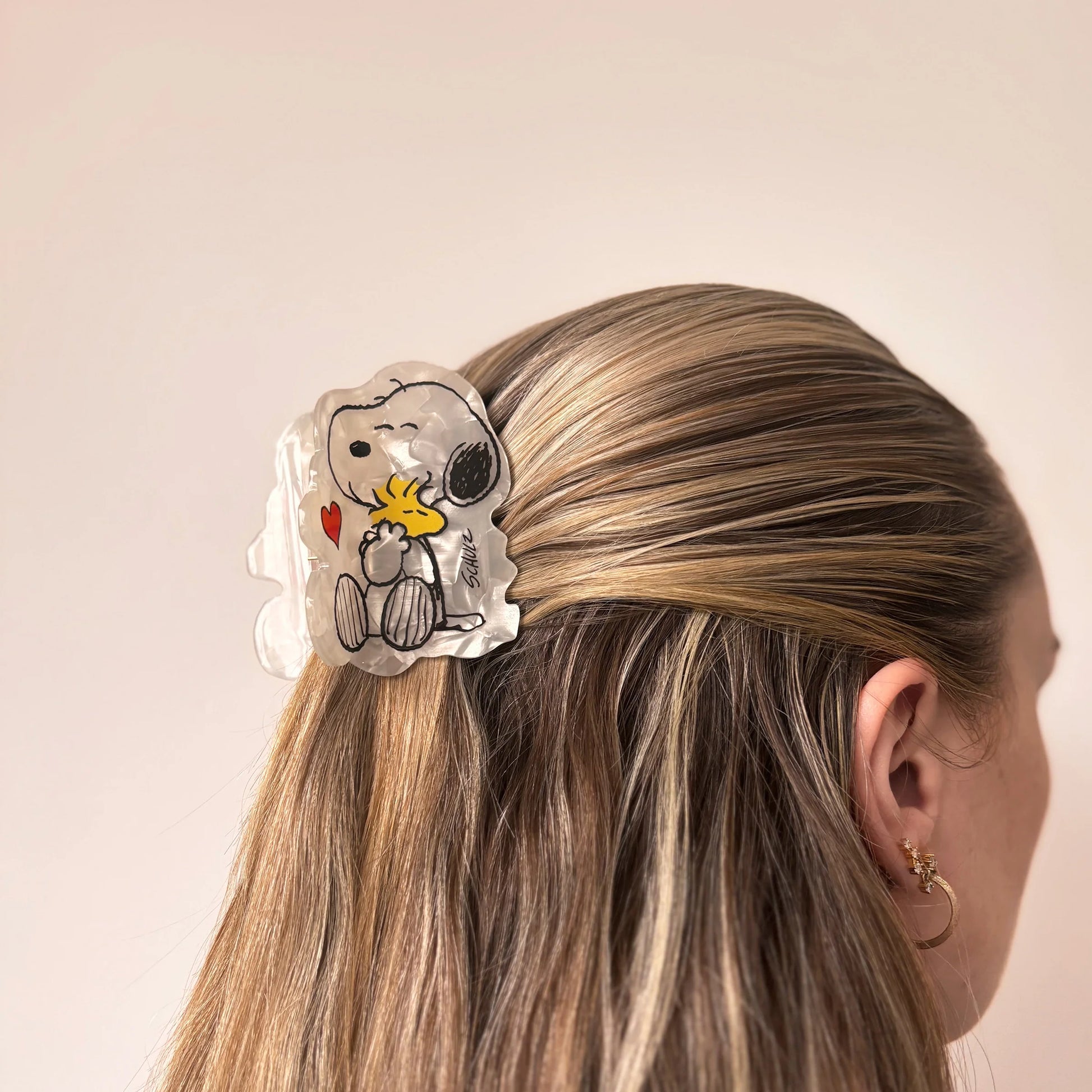 Peanuts character hair claw shown from side angle.