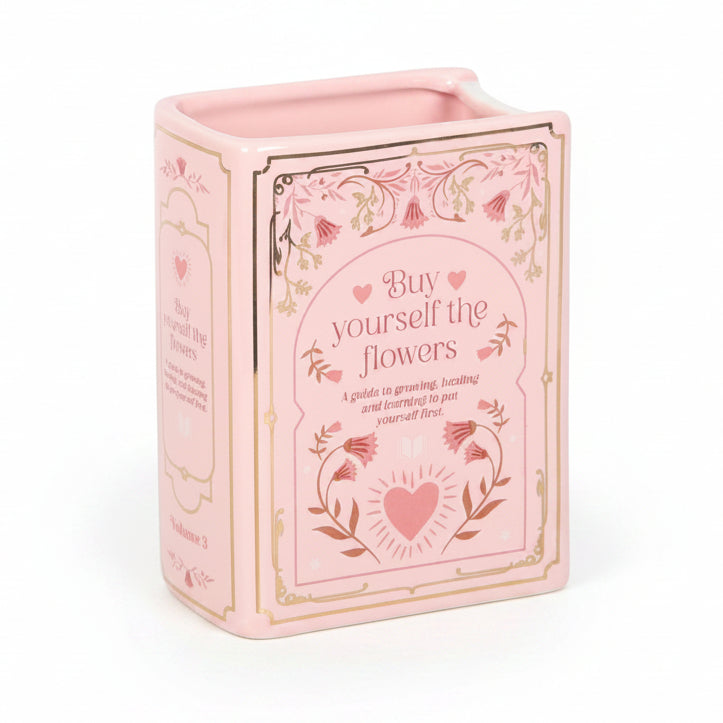 Pink ceramic book shaped vase with floral detailing and heart motif – unique decorative vase for book lovers.