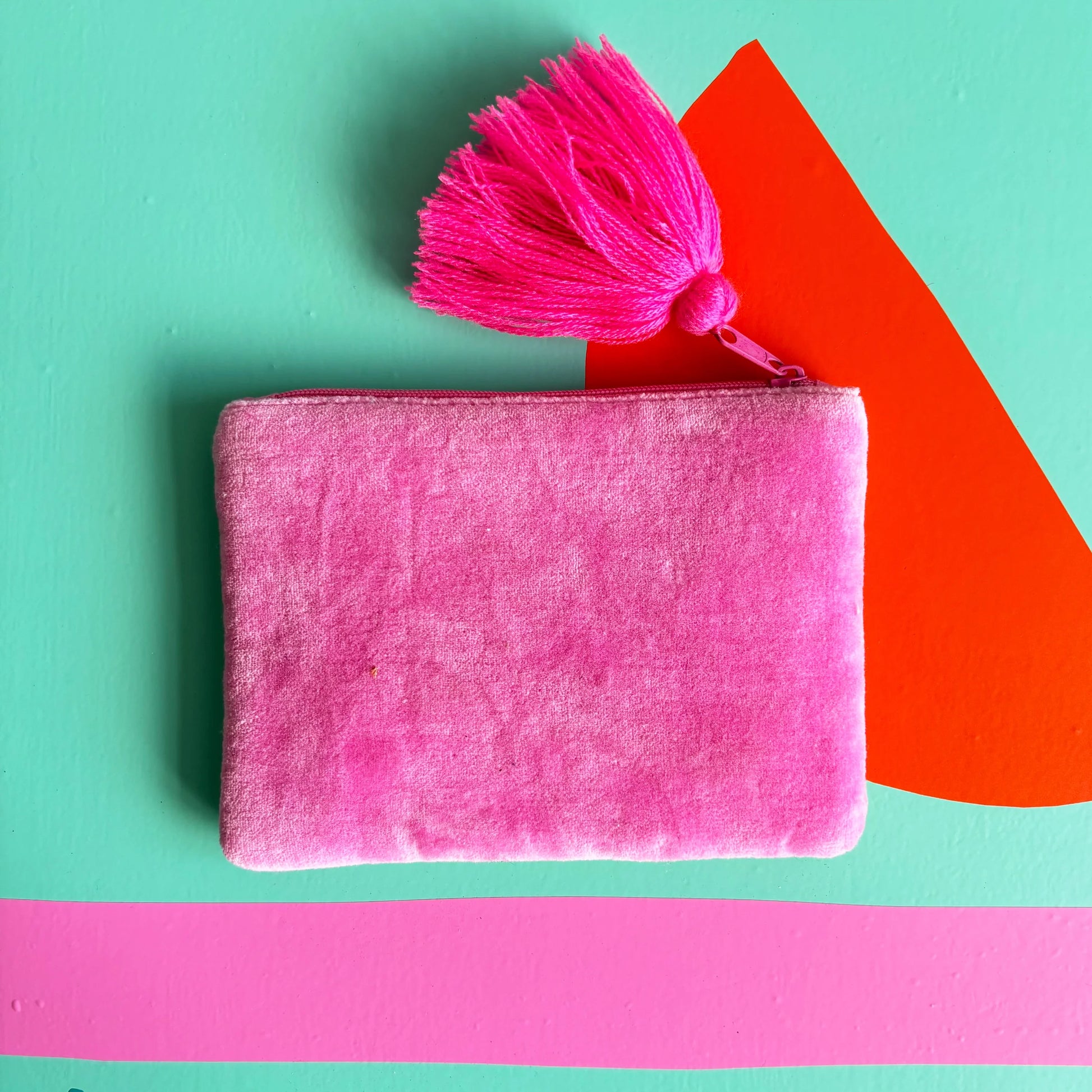 Back of pouch in soft pink velvet fabric.