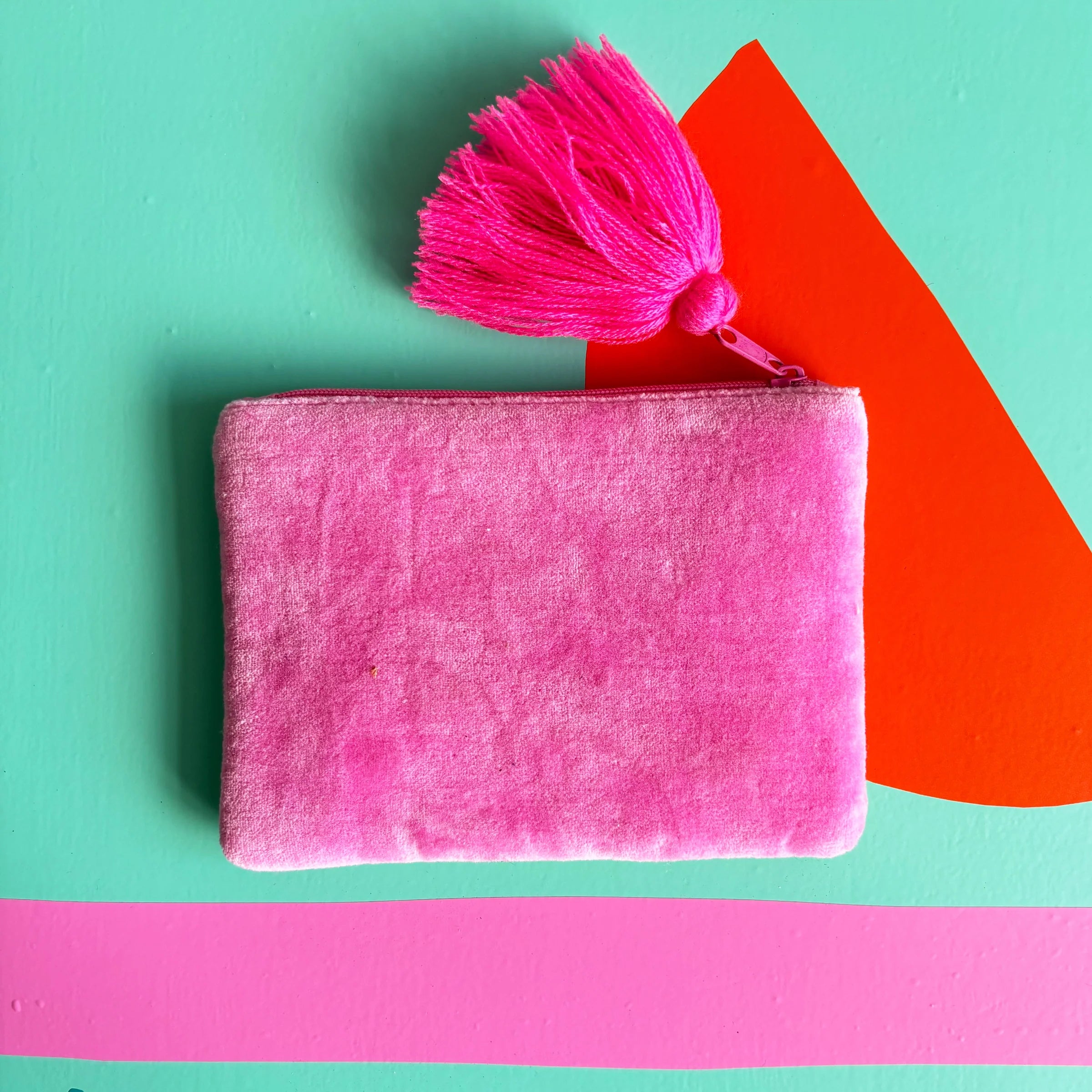 Back of pouch in soft pink velvet fabric.