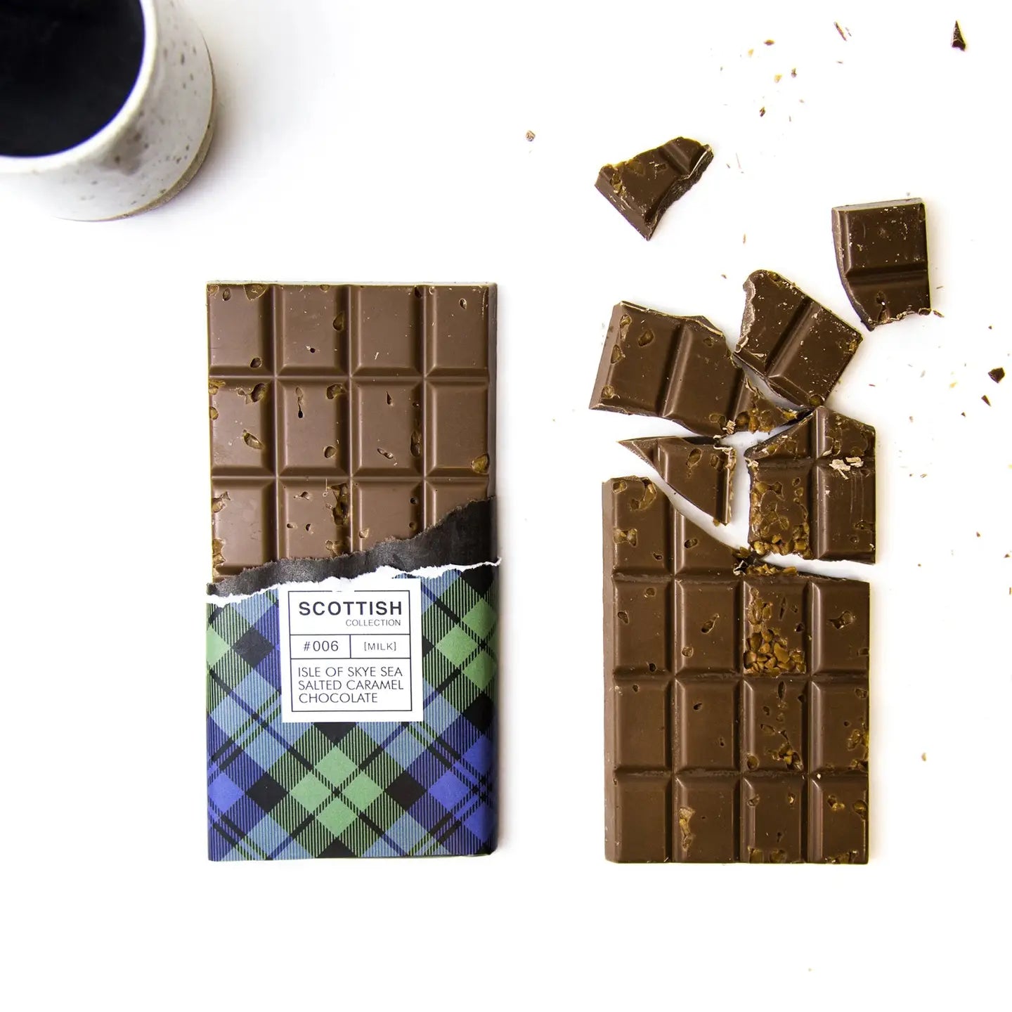 Handmade Isle of Skye Sea Salt Caramel Chocolate Bar with crunchy caramel flakes and sea salt, wrapped in green and blue tartan paper.