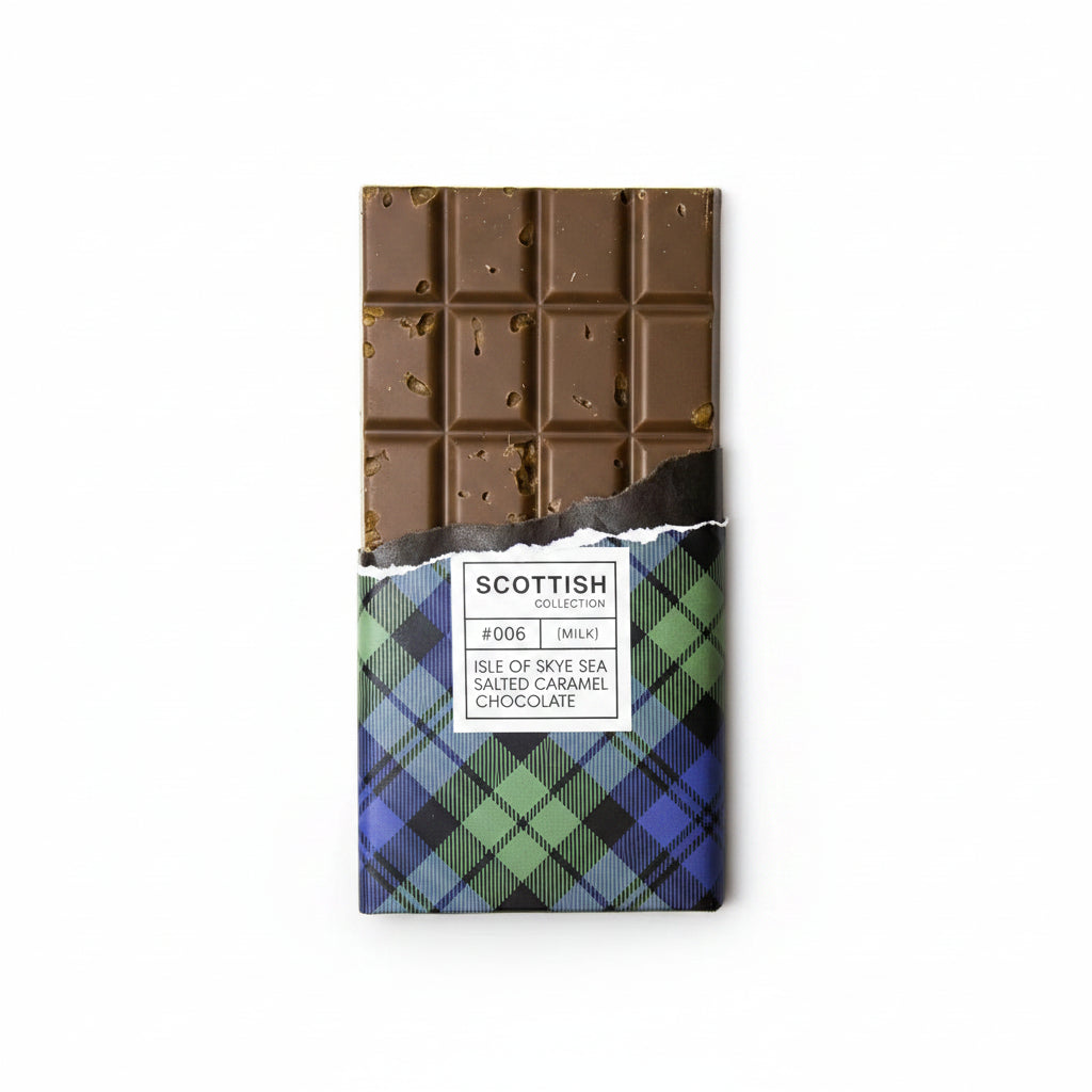A chocolate bar with its wrapper partially torn off, placed beside broken pieces of the same chocolate on a white surface. The wrapper has a plaid pattern in blue, green, and black, with a white label that reads 'SCOTTISH chocolate'.