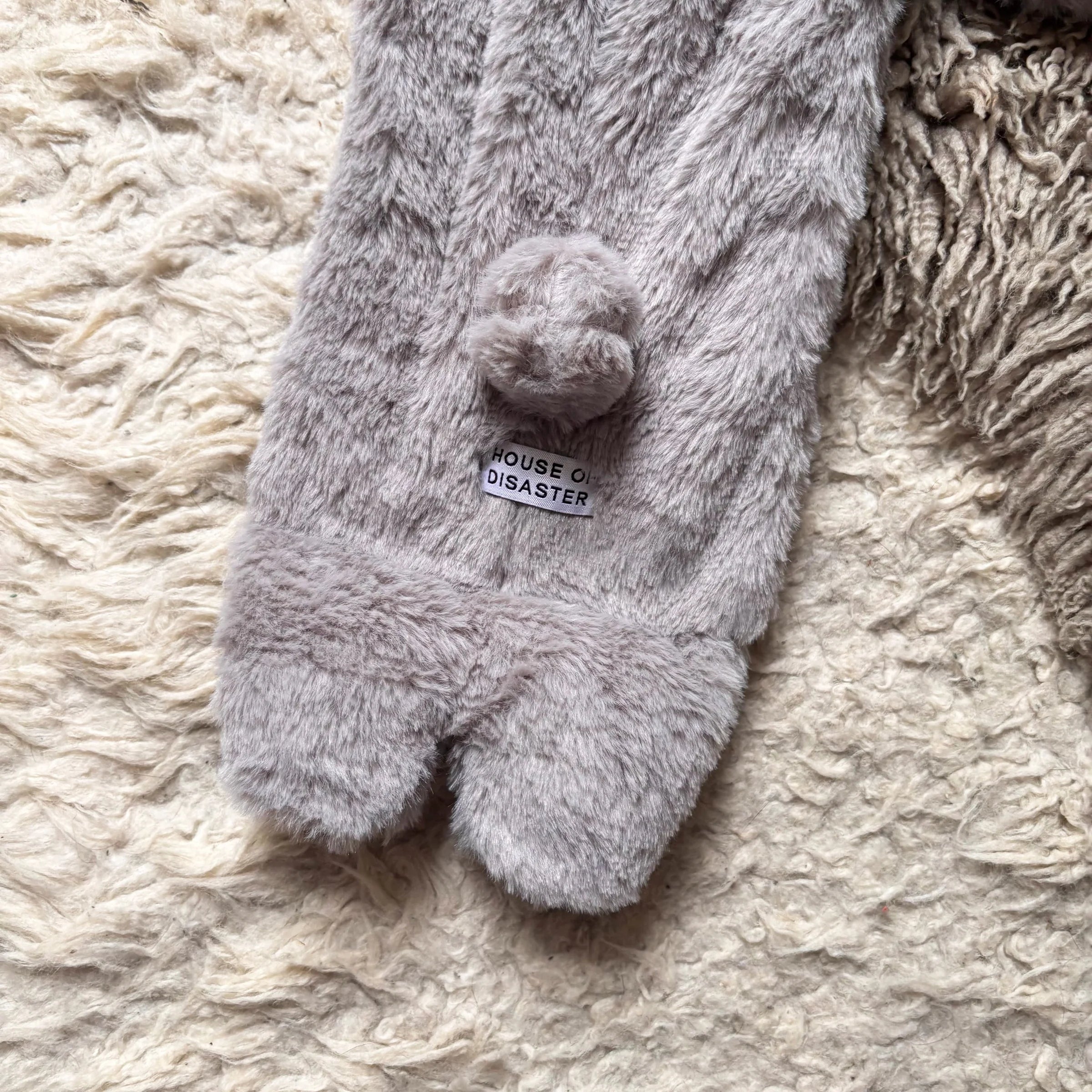 Close-up of bunny tail and brand tag detail.