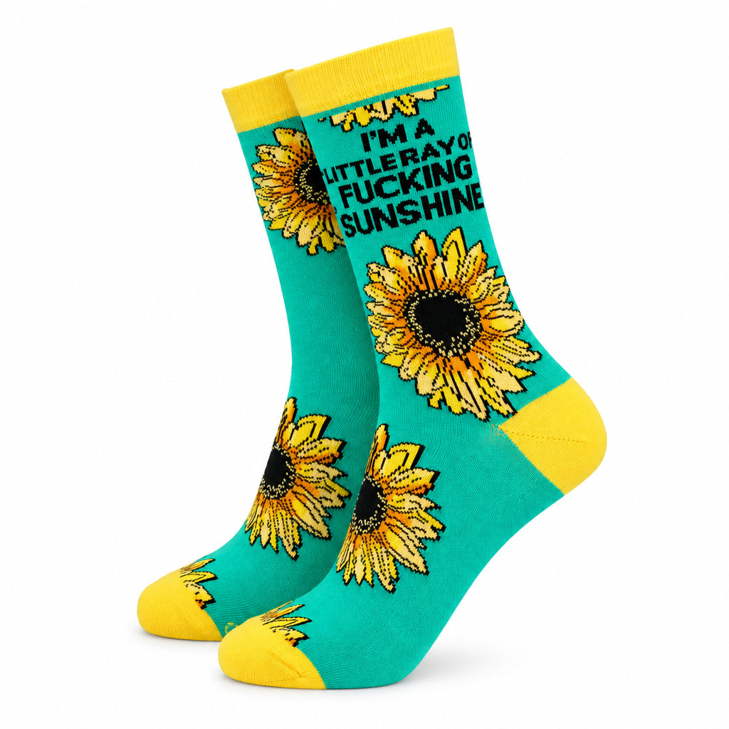 Women’s bamboo socks with sunflower design and text “I’m a little ray of fucking sunshine” in bold black font on a bright teal background with yellow heel and toe.