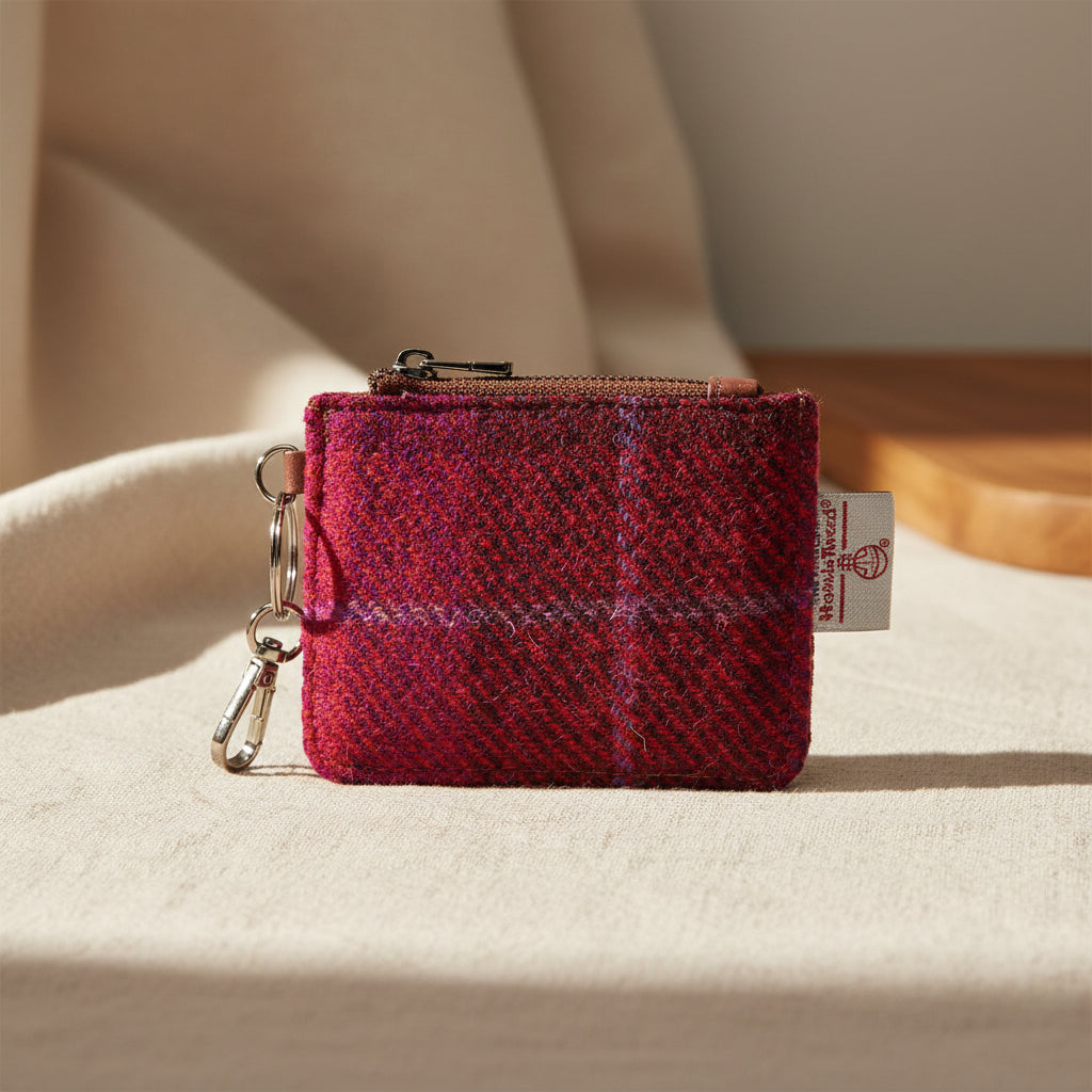 Red and purple plaid coin purse with a key ring on a white background