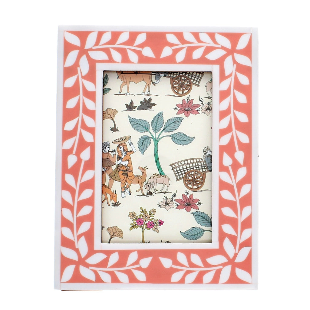 Front view of pink and white leaf-patterned resin photo frame with glass insert.