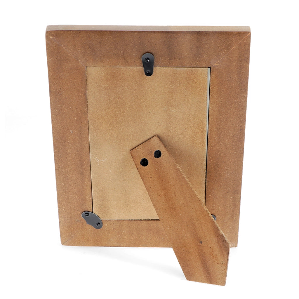Back view of wooden photo frame with hinged tabletop stand and wall hook.