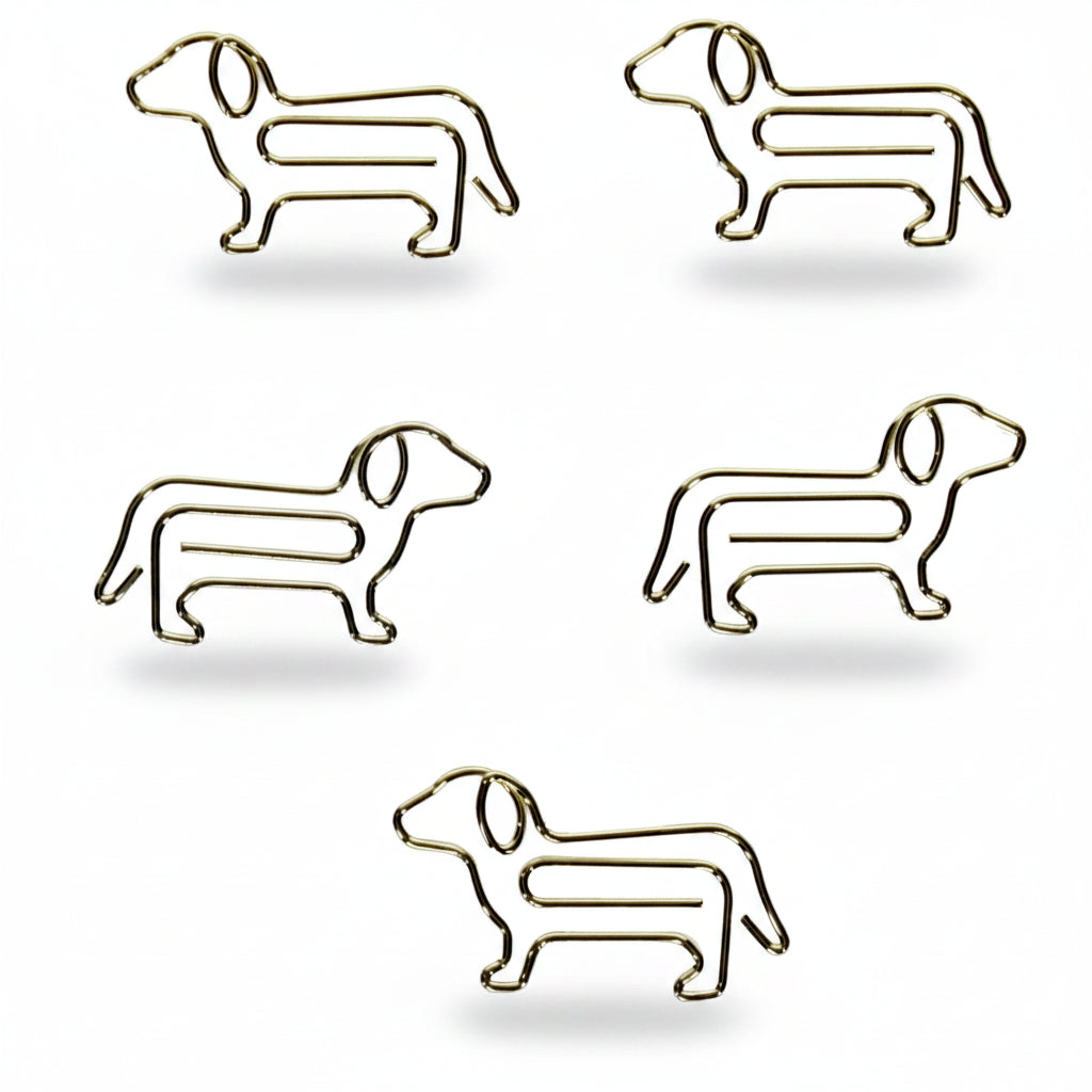 Close-up of five individual gold dog-shaped paper clips laid out on a white background, showing their sleek metal design and charming silhouette detail.
