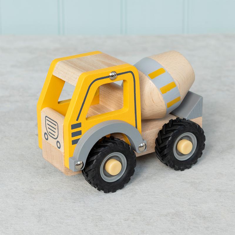 Yellow wooden push along cement mixer toy on grey background